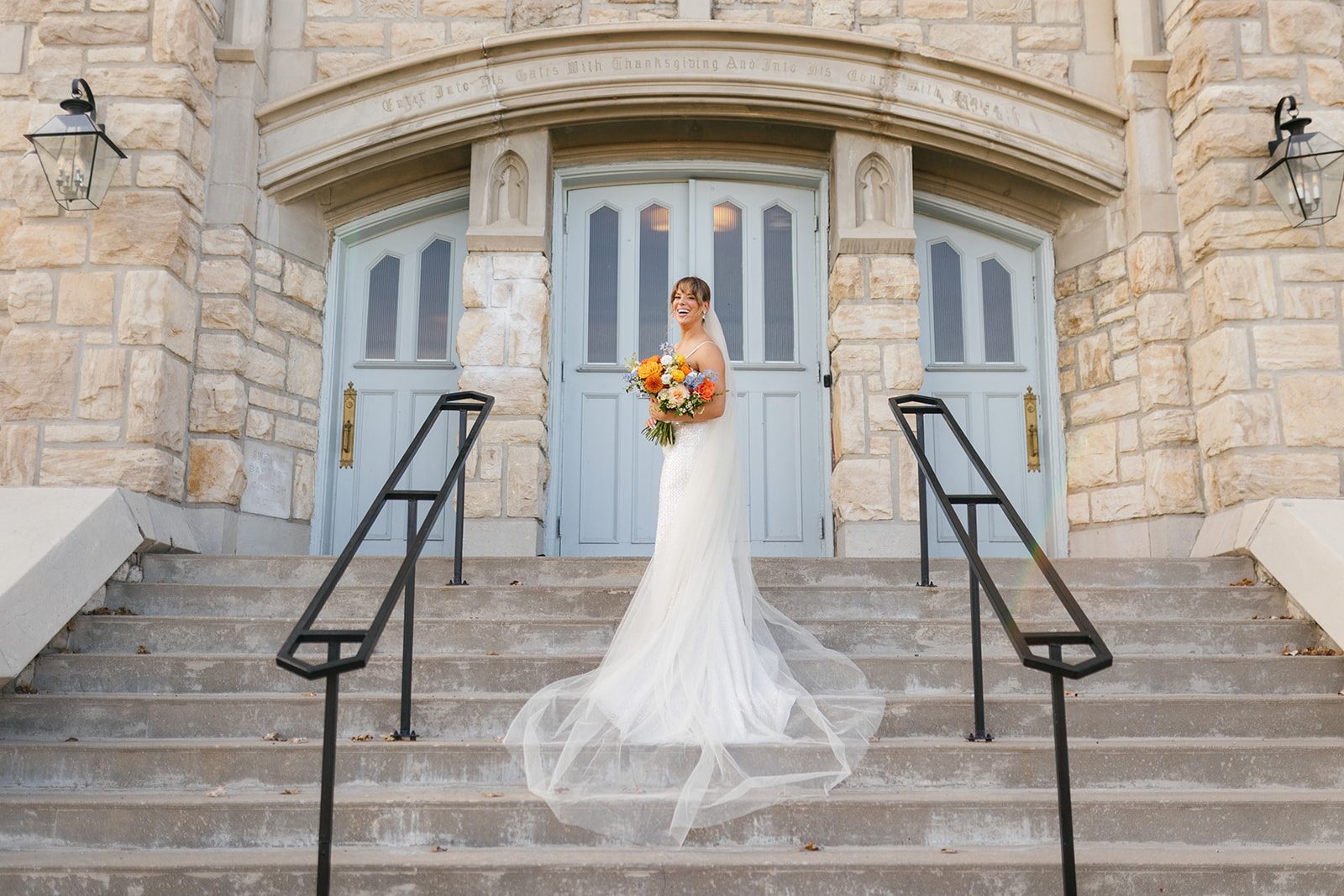 Couple portrait beneath the arches of the restored 1922 church