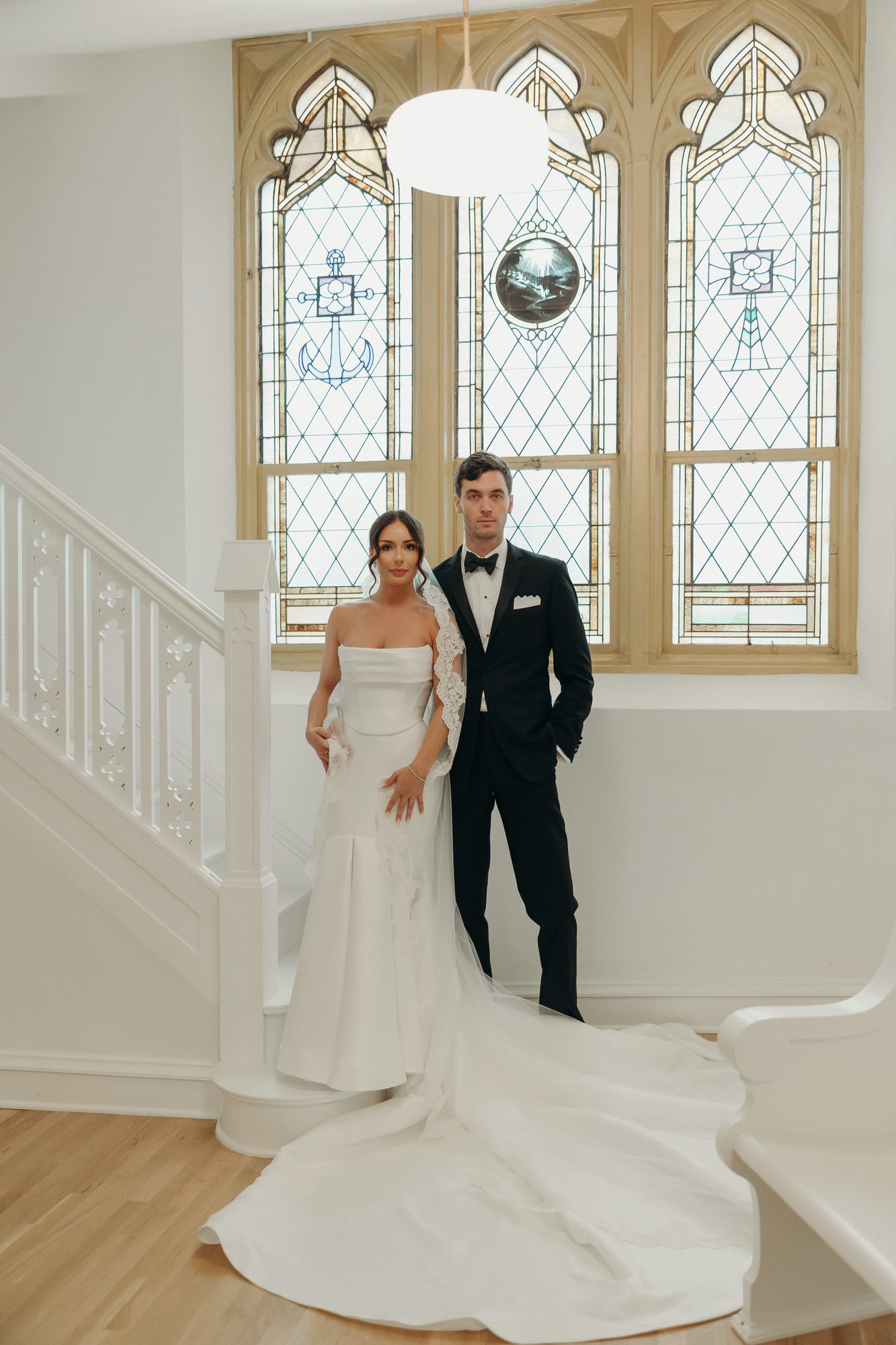 Editorial wedding portrait against the stained glass at Melrose Abbey