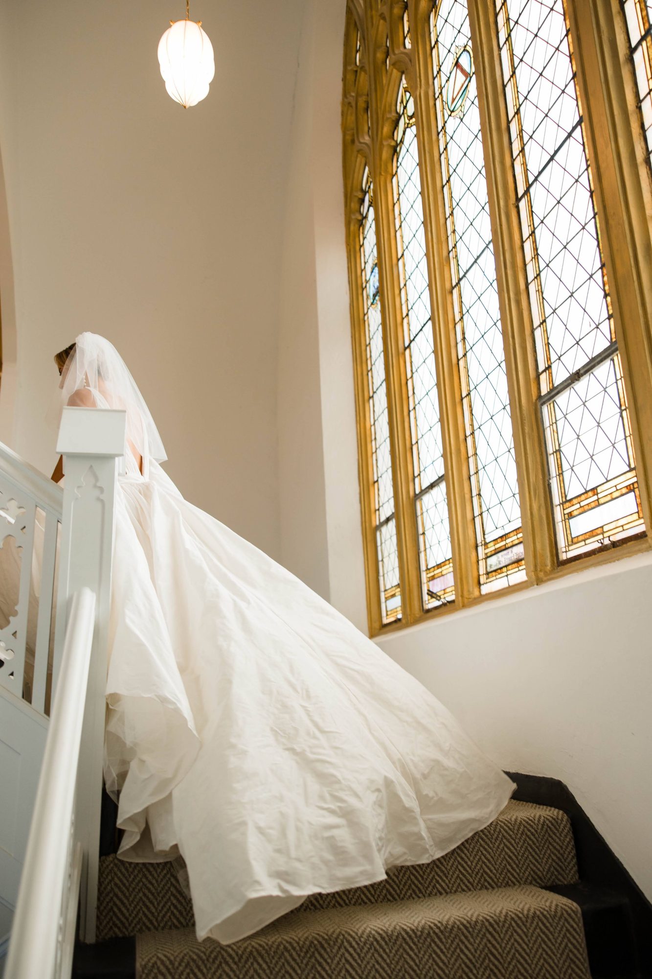 Couple portrait beneath the arches of the restored 1922 church